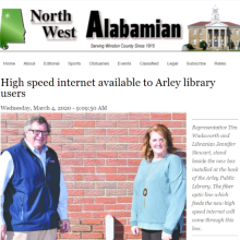 Thumbnail Image Representative Tim Wadsworth and Librarian Jennifer Stewart, stand beside the new box installed at the back of the Arley Public Library.