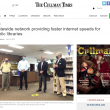 Thumbnail Image of newspaper article with picture of 4 men standing to talk in library.