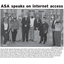 Thumbnail Image of men and women standing together in library