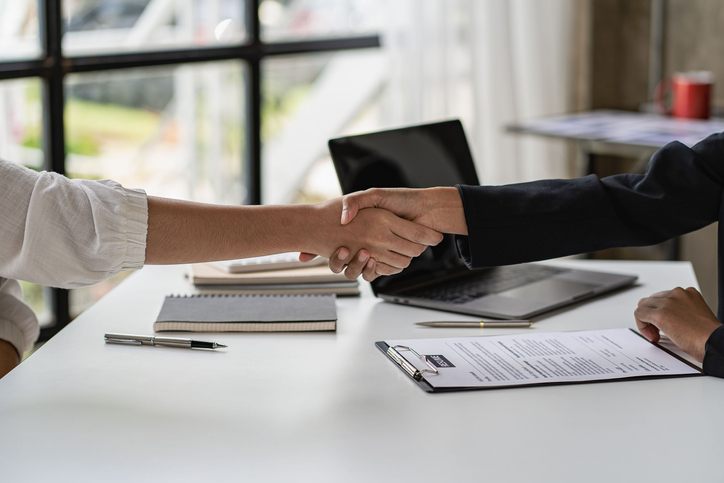 Handshake between professionals over a modern desk
