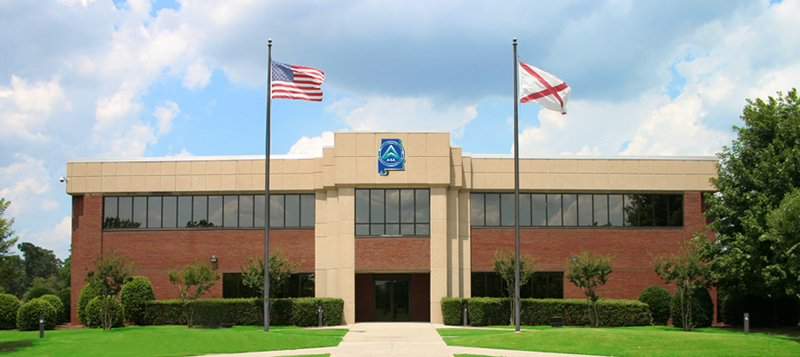 Front view of Alabama Supercomputer Center brick and stucko building on a sunny day