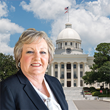 Photo of Debra Wallace with Alabama state capitol in background