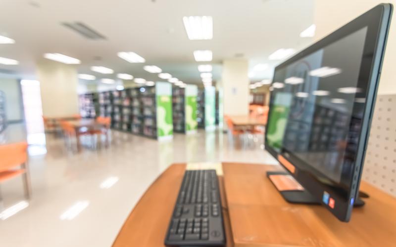 Library interior with screen and keyboard focused in foreground