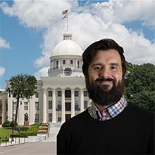 Photo of Jesse Rozar with Alabama state capitol in background