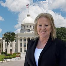 Photo of Liz Burgess with Alabama state capitol in background
