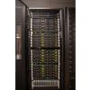 Front view of tall black supercomputer rack with door open to showcase multiple computing nodes with multicolored led lights